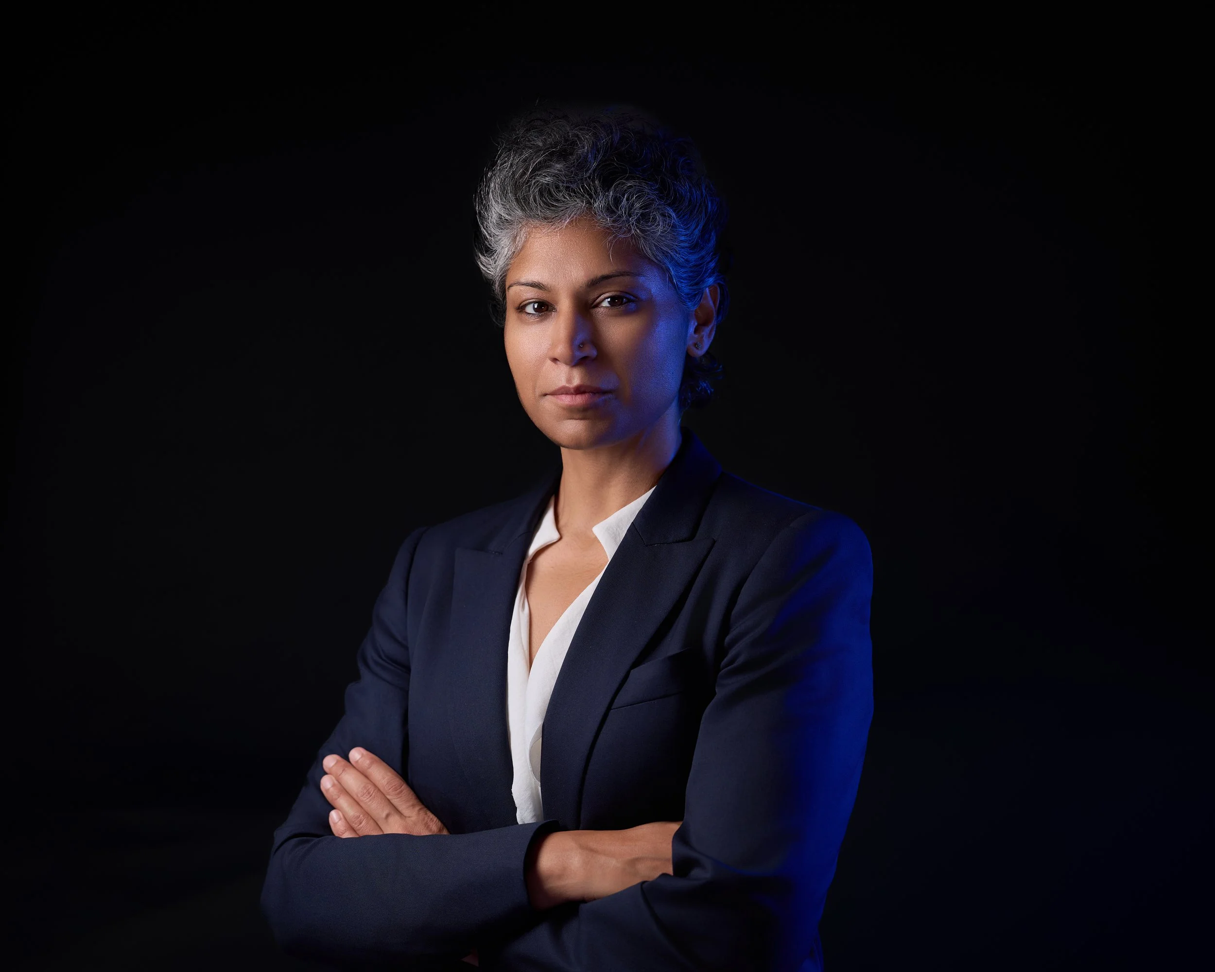 Professional headshot of a physician with silver hair for a practice website