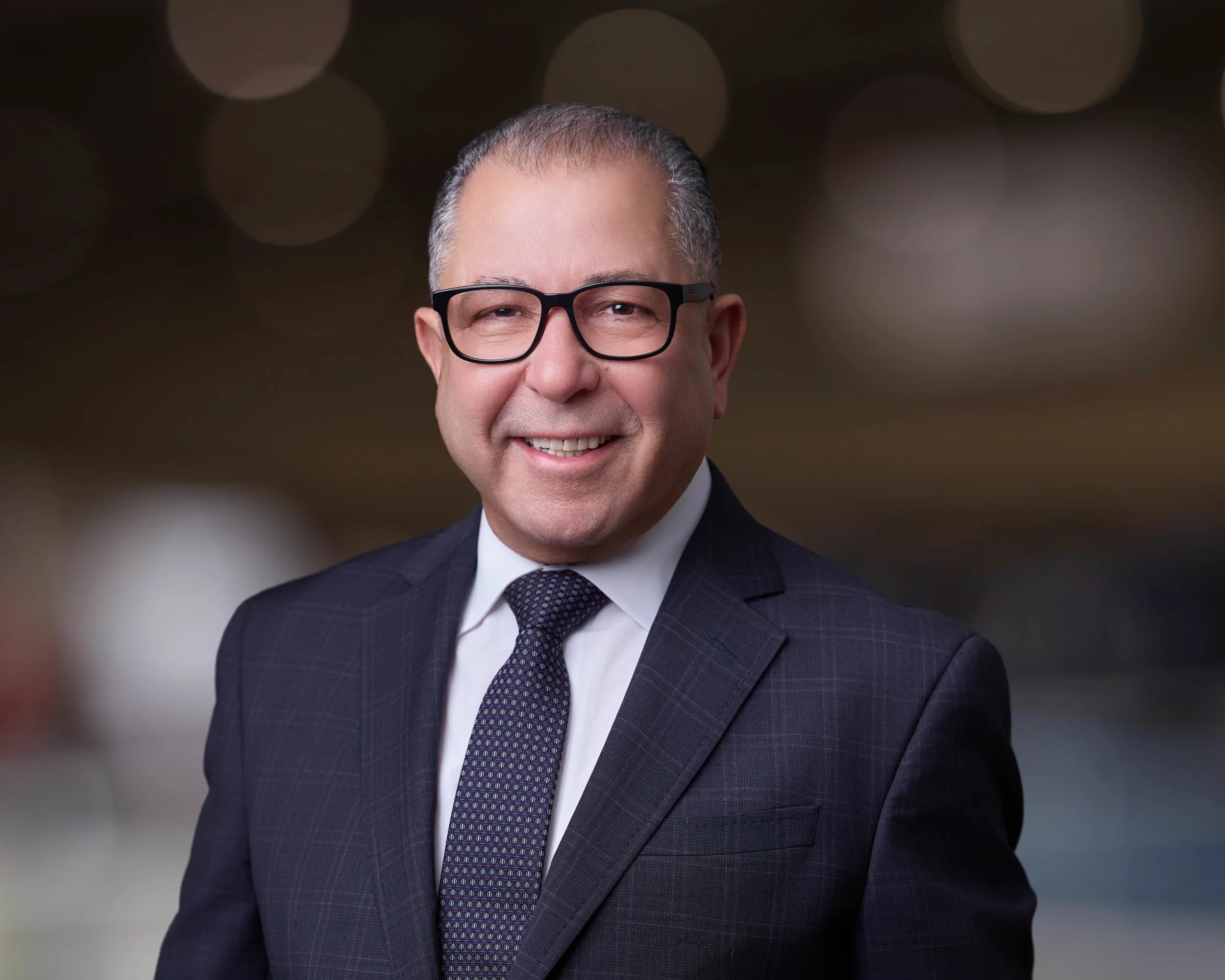 Business executive portrait photographed in a modern office setting