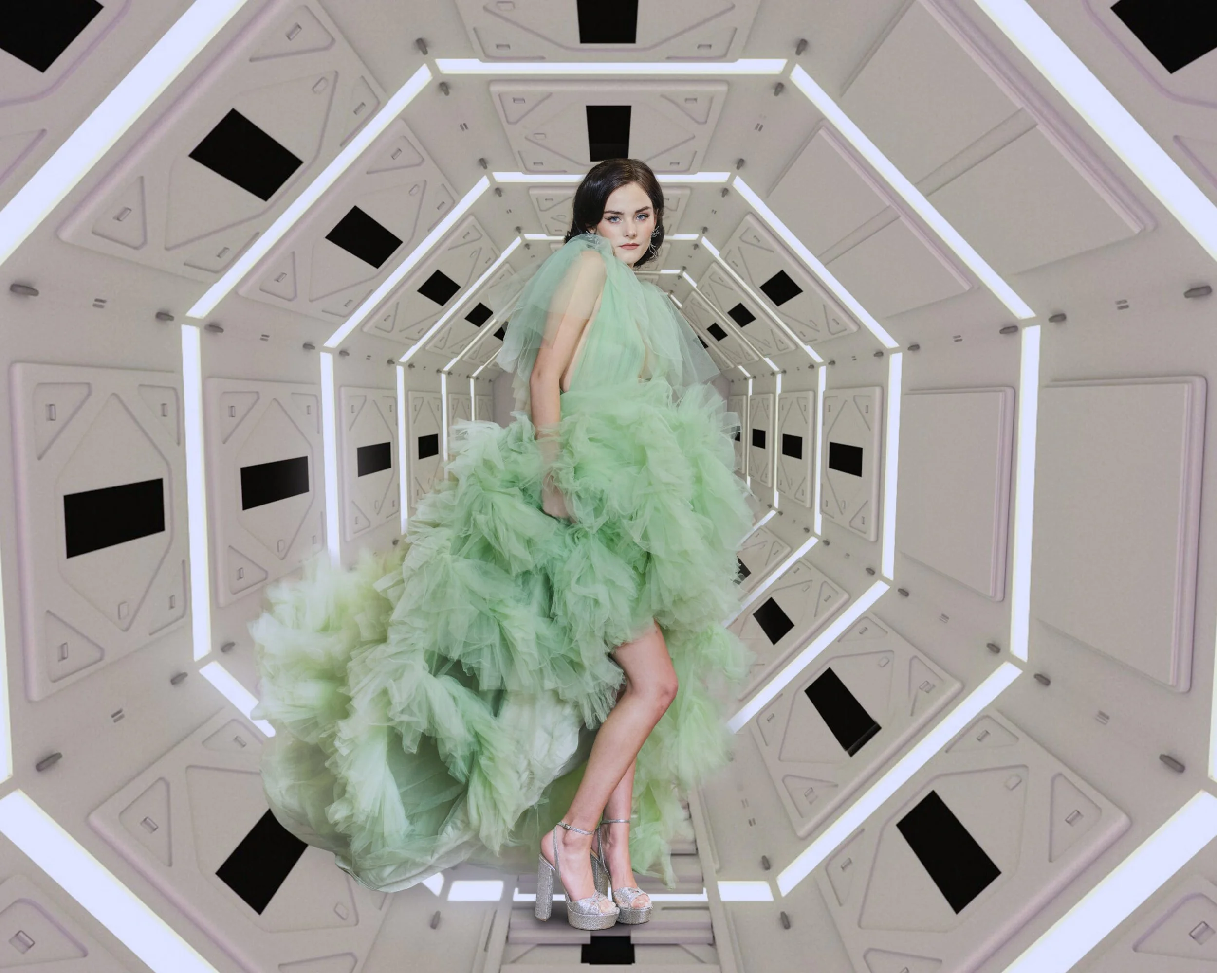 High fashion editorial of a model in a mint ruffled gown on a white geometric set