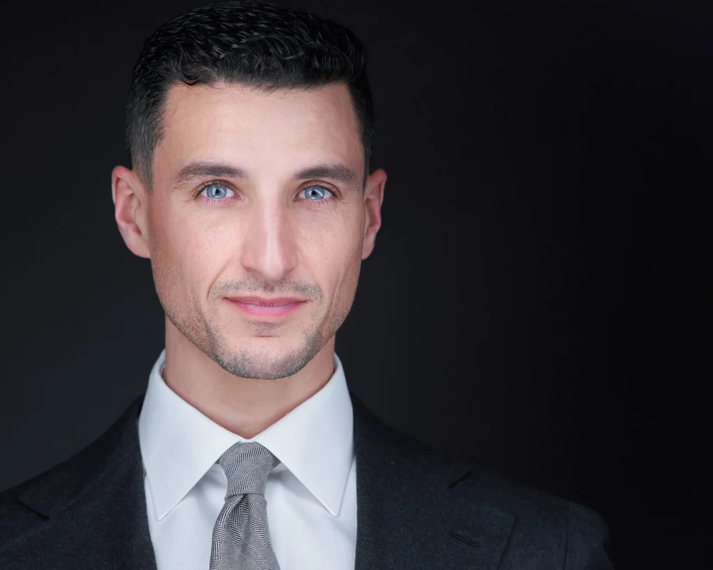 Attorney headshot in a dark suit photographed for a Birmingham area law firm bio page