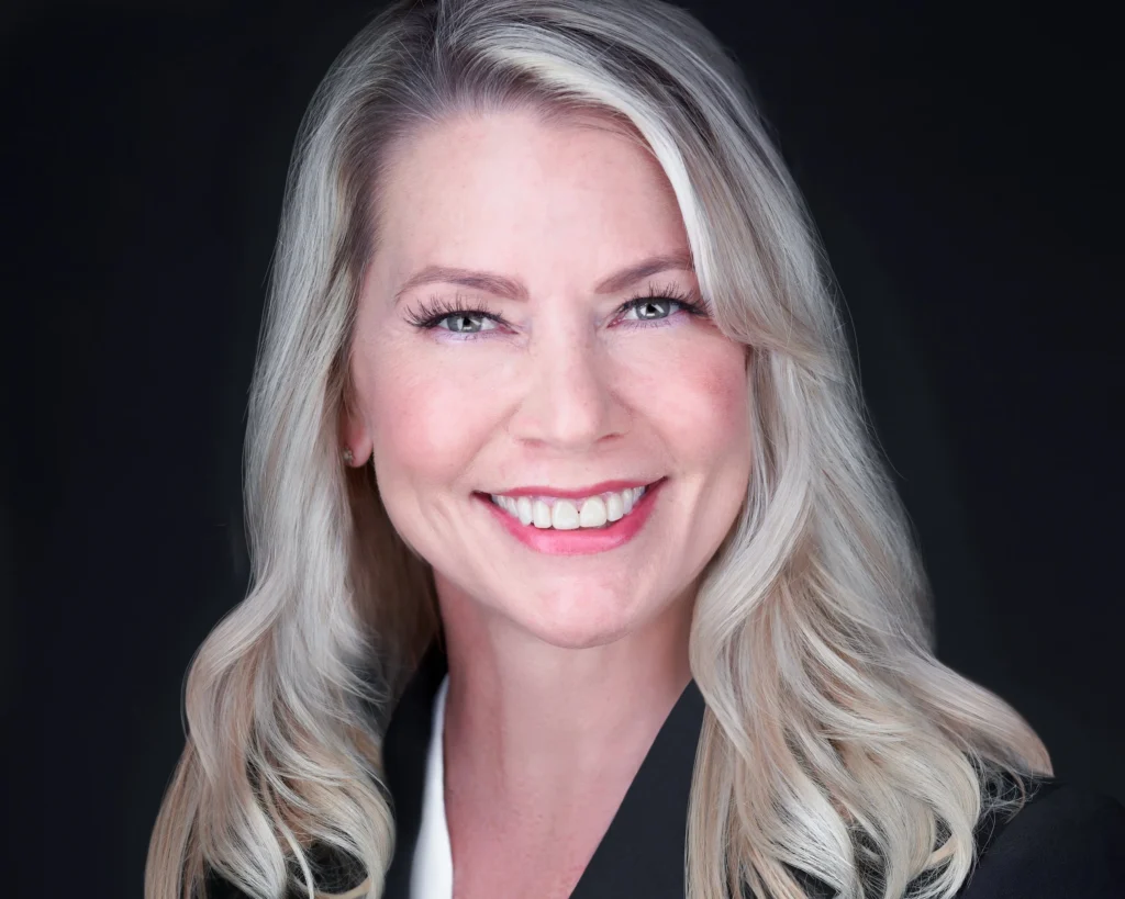 Portrait with natural makeup and soft waves against a dark background