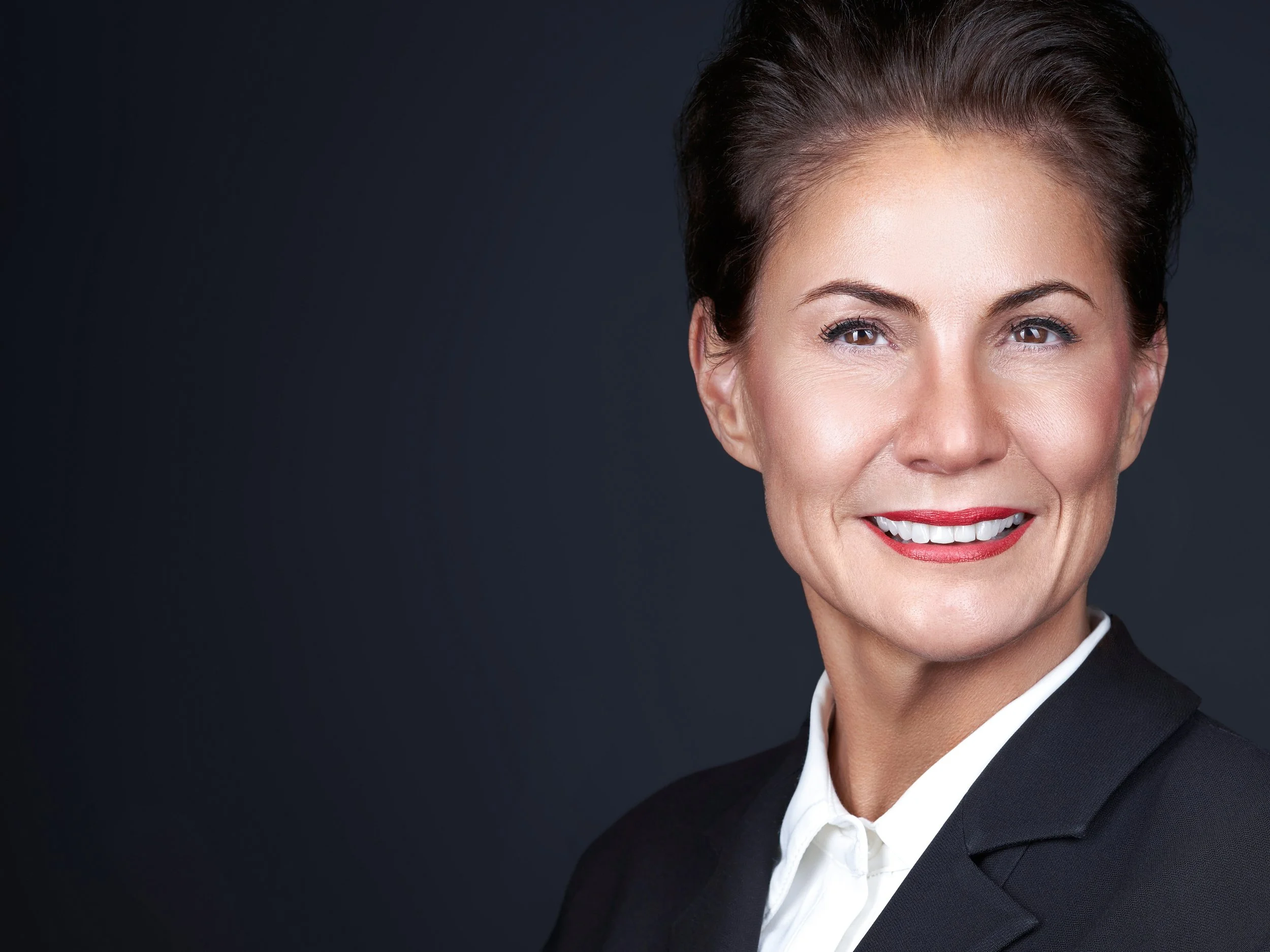 Corporate headshot of a professional woman photographed on-site at an office